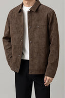 Brown suede jacket worn by a person on a gray background