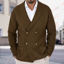 Man wearing a brown double-breasted jacket with a blurred street background