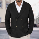Man wearing a black double-breasted jacket with gold buttons in an urban setting