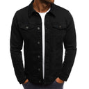 Black denim jacket worn by a person on a white background