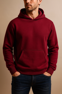 Man wearing a red hoodie against a beige background