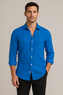 Man wearing a blue shirt against a beige background