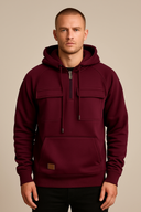 Man wearing a burgundy hoodie with a beige background
