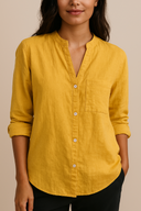 Woman wearing a mustard yellow shirt against a beige background