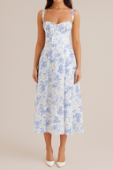 Woman wearing a blue floral dress on a beige background