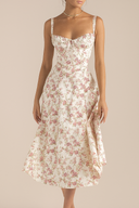 Woman wearing a floral dress against a beige background