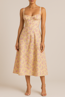 Woman wearing a floral dress against a plain background