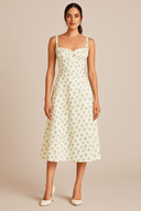 Woman wearing a floral dress against a beige background