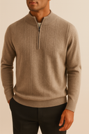 Man wearing a beige half-zip sweater against a beige background