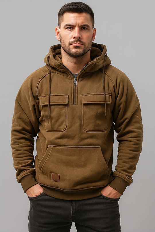 Man wearing a brown hoodie against a gray background