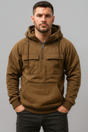 Man wearing a brown hoodie against a gray background