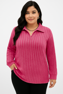 Woman wearing a pink ribbed sweater on a white background