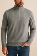 Man wearing a gray half-zip sweater against a beige background