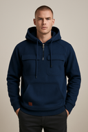 Man wearing a navy blue hoodie on a beige background