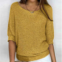 Yellow knitted sweater worn by a person on a white background