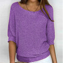 Purple knitted sweater worn by a person on a white background