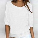 White textured top worn by a person on a plain background