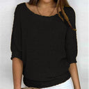 Black sweater worn by a person on a white background
