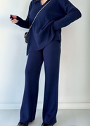 Person wearing a navy blue outfit against a white background