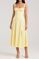 Woman wearing a yellow dress against a white background
