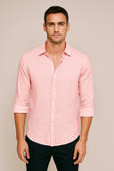 Man wearing a light pink shirt against a beige background