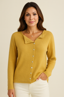 Woman wearing a yellow cardigan against a beige background