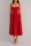 Red dress worn by a model on a plain background