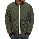 Green quilted jacket worn by a person on a white background