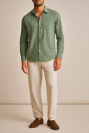 Man wearing A longsleeve men's linen set, consisting of a green shirt and beige pants