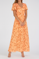 Woman wearing an orange floral dress on a white background