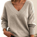 Gray sweater worn by a person with a neutral background