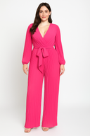 Woman wearing a bright pink jumpsuit on a white background