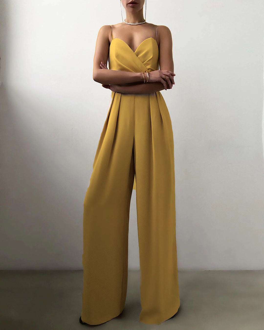 Yellow jumpsuit worn by a person on a plain background