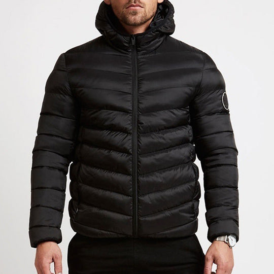 Black puffer jacket worn by a person on a light gray background
