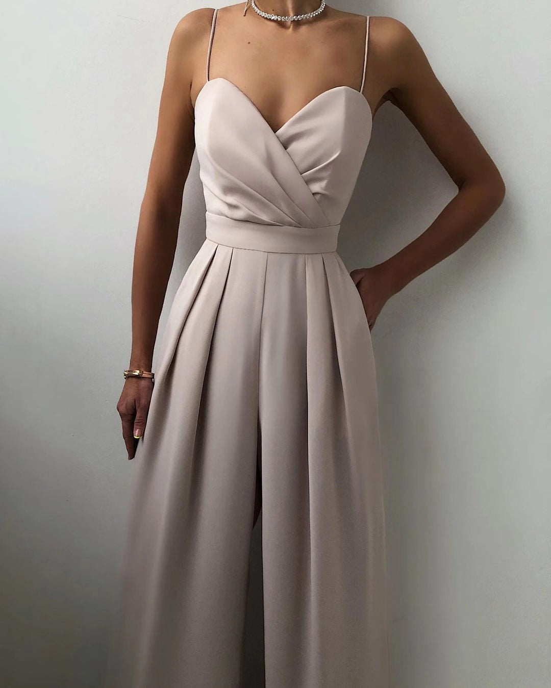 Beige evening gown worn by a model against a plain background