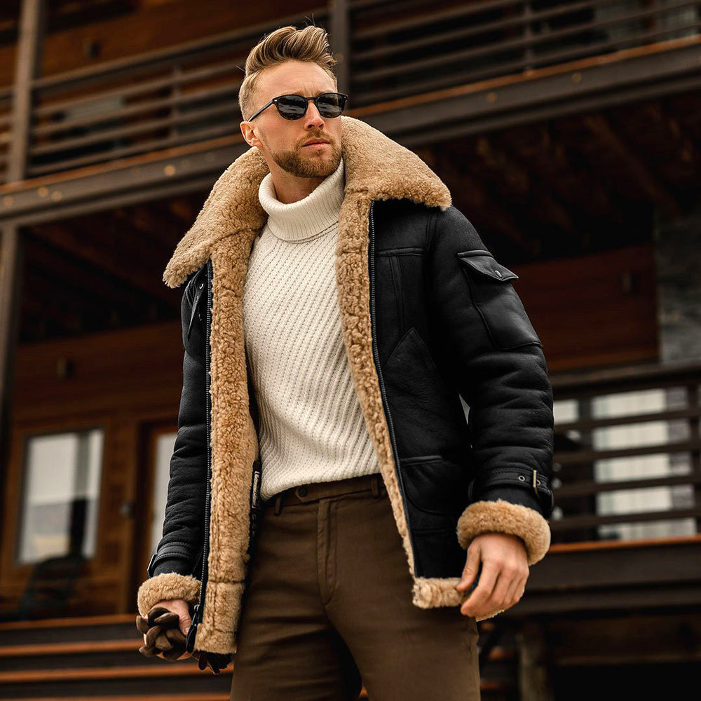Man wearing a black shearling jacket with a wooden building in the background