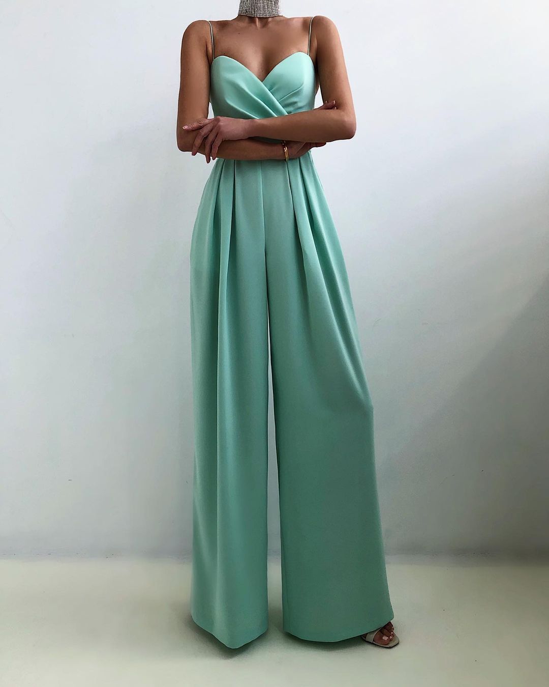 Mint green strapless jumpsuit on a plain background