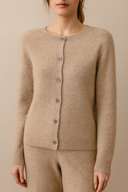 Beige cardigan worn by a person on a beige background