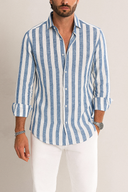 Man wearing a blue and white striped shirt with rolled-up sleeves against a neutral background
