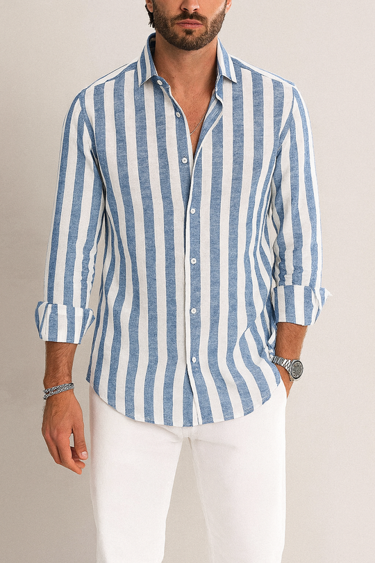 Man wearing a blue and white striped shirt with rolled-up sleeves against a neutral background