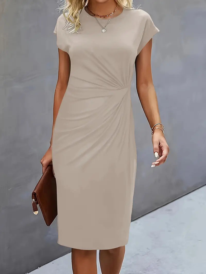Woman wearing a beige dress against a gray background