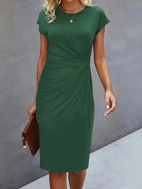 Green dress worn by a person against a gray background