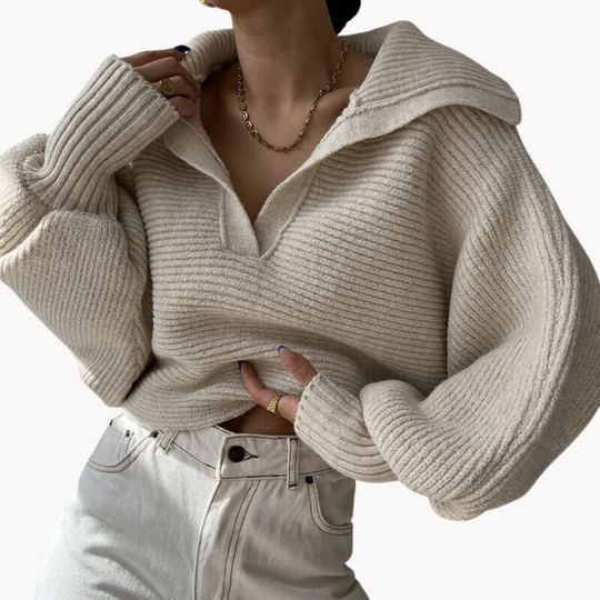 Beige ribbed sweater worn by a person on a white background