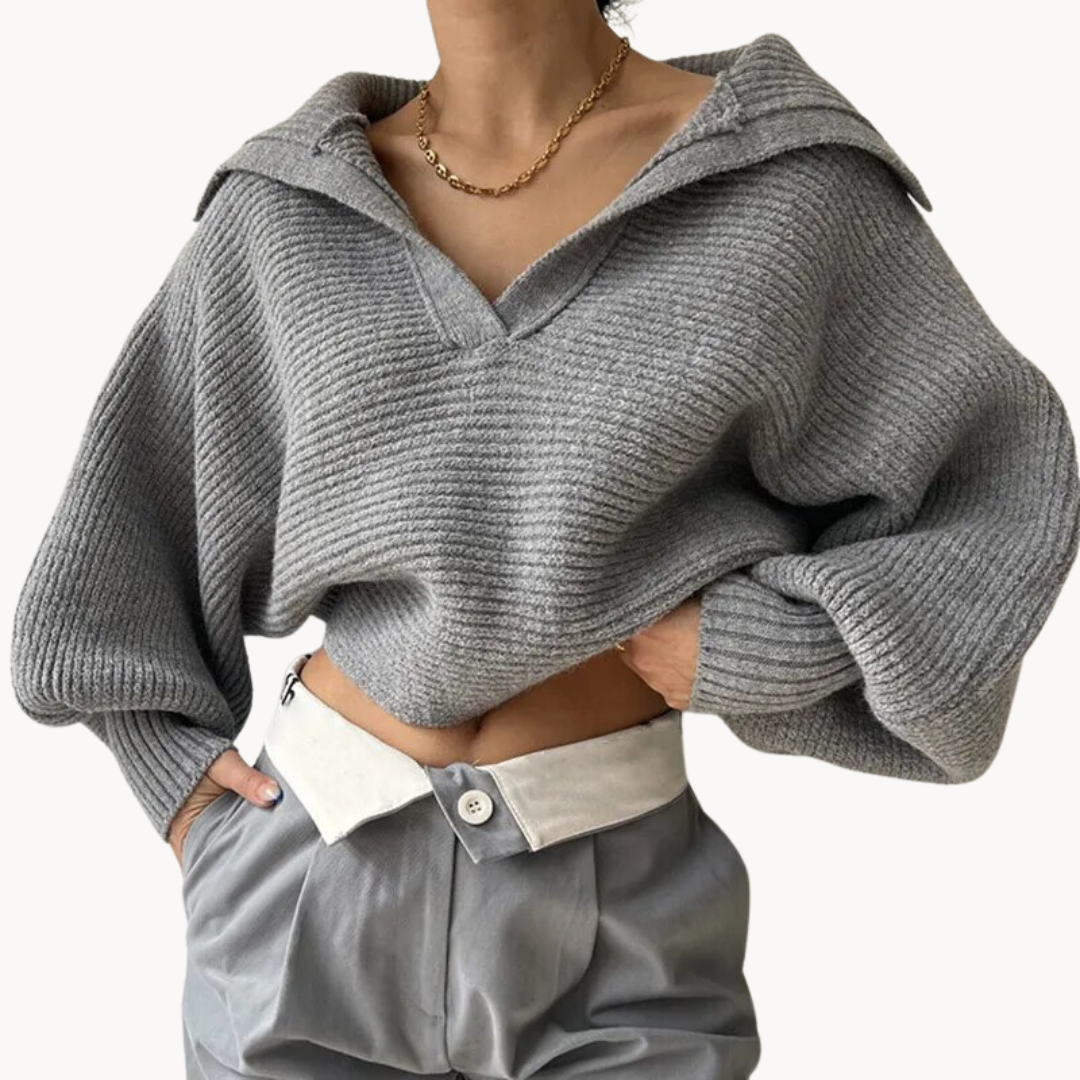 Person wearing a gray ribbed hoodie and pants on a white background