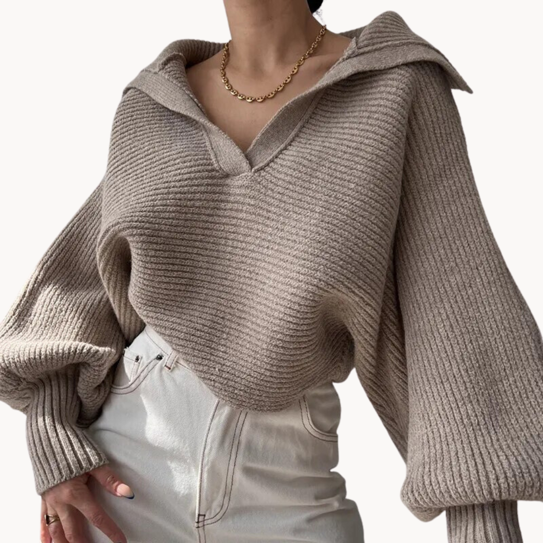 Beige knitted sweater worn by a person on a white background