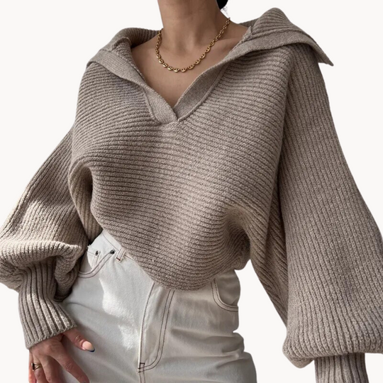 Beige knitted sweater worn by a person on a white background