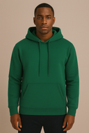 Man wearing a green hoodie against a beige background