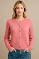 Woman wearing a pink cardigan with a beige background