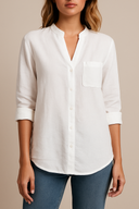 White button-up shirt worn by a person on a beige background