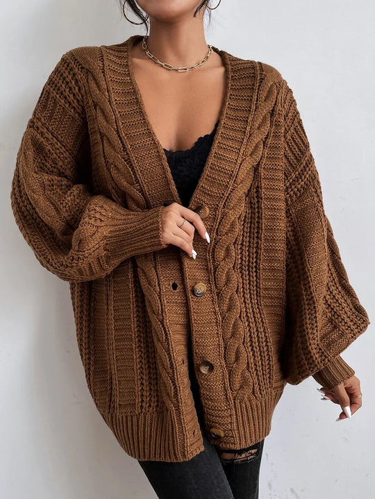 Brown knitted cardigan worn by a person against a white background